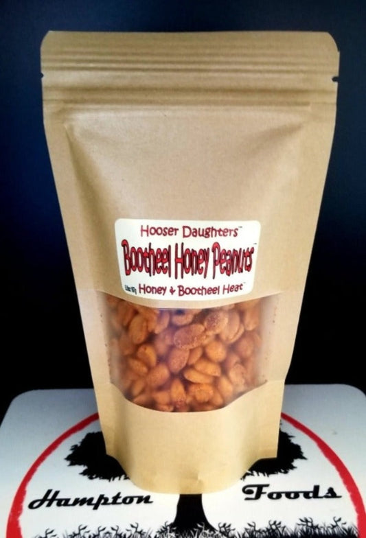 Hooser Daughters™' irresistible snack sensation: Bootheel Honey Peanuts! The perfect blend of sweet-heat with honey-roasted peanuts infused with our exclusive Bootheel Heat™ seasoning. Each crunchy bite bursts with the tantalizing harmony of honey sweetness and a kick of spicy heat, leaving you craving more.