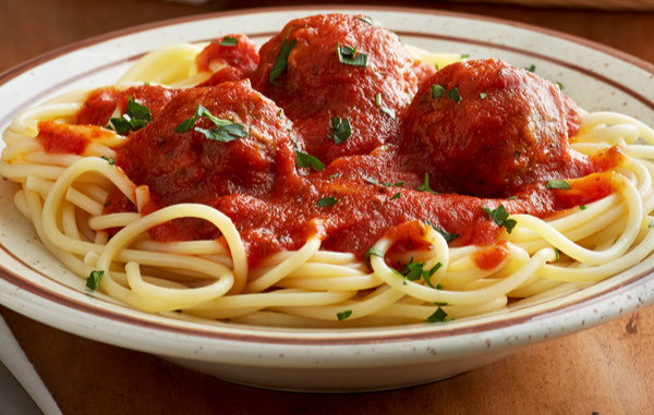 pasta sauce, meatballs, spaghetti, in a plate on wooden table